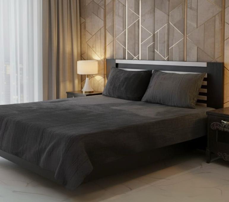 Modern bedroom with a bed, nightstands, and decorative wall.